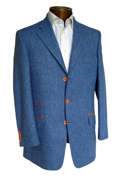 Blue herringbone tweed suit with gold trim and buttons